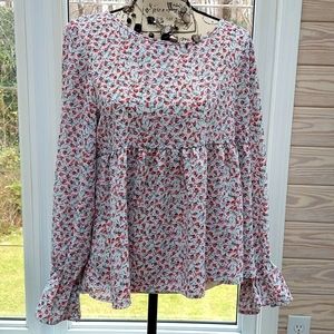 Women's size large top with bell sleeves.